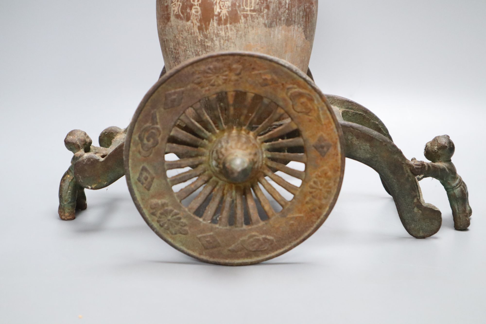 A Chinese pottery vase, with an iron carriage base, Han dynasty or later, height overall 28cm
